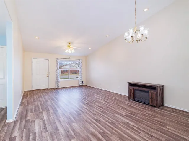 a view of livingroom with hardwood floor and kitchen view
