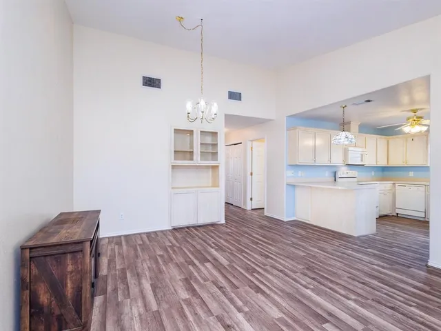a view of a kitchen with wooden floor and a sink