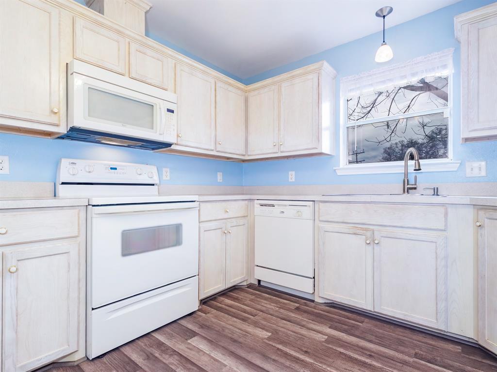 202 Abby Road Early, TX 76802 - Photo 9 of 28 a kitchen with cabinets appliances a sink and a window