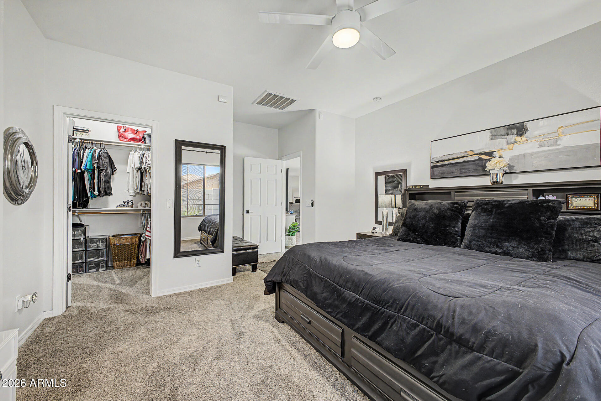 4924 West Harwell Road Laveen, AZ 85339 - Photo 14 of 27 a bedroom with a large bed and a chandelier
