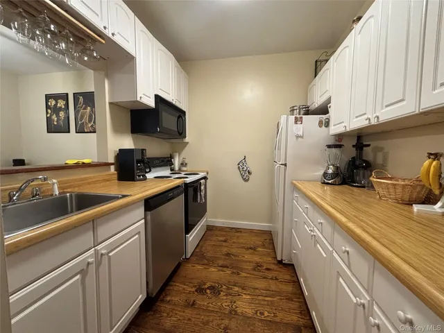 a kitchen with a sink and a stove top oven
