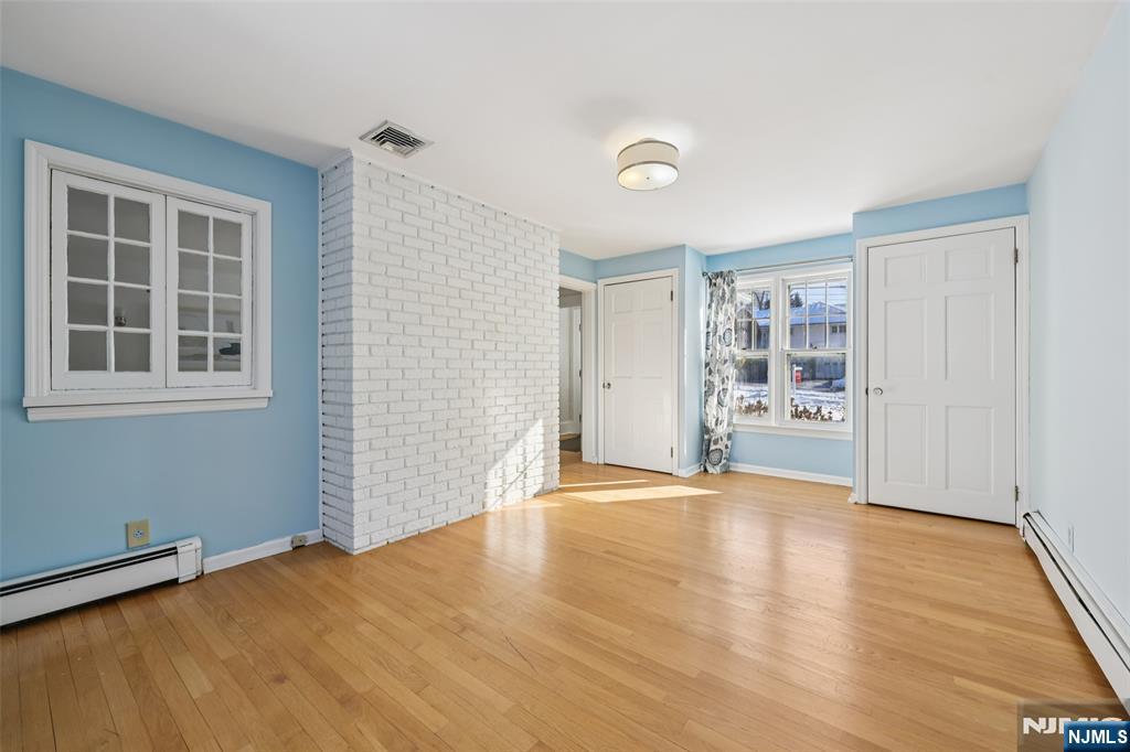 520 Hillcrest Road Ridgewood, NJ 07450 - Photo 14 of 27 an empty room with wooden floor and windows