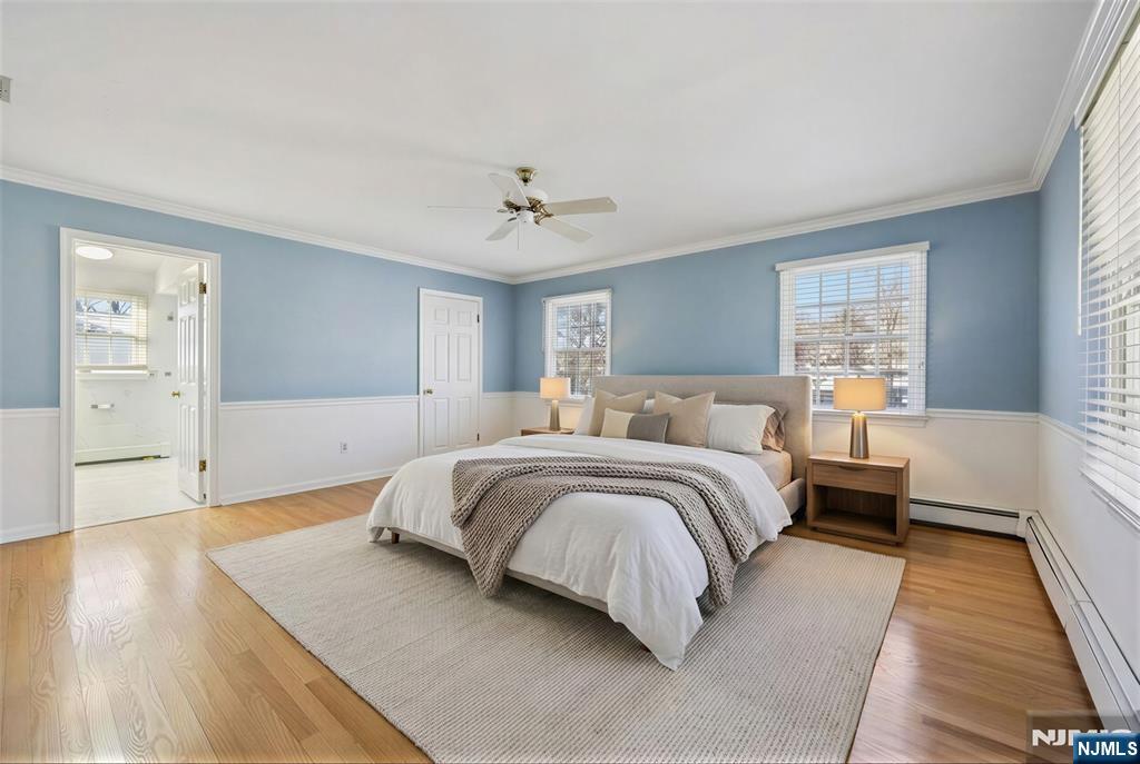 520 Hillcrest Road Ridgewood, NJ 07450 - Photo 16 of 27 a spacious bedroom with a large bed and a chandelier
