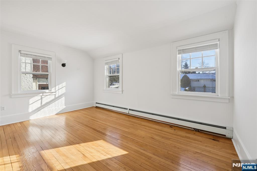 520 Hillcrest Road Ridgewood, NJ 07450 - Photo 20 of 27 a view of an empty room with wooden floor and a window