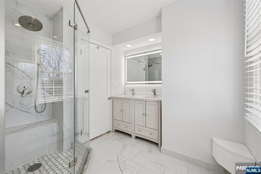 520 Hillcrest Road Ridgewood, NJ 07450 - Photo 21 of 27 a bathroom with a granite countertop sink a toilet and shower