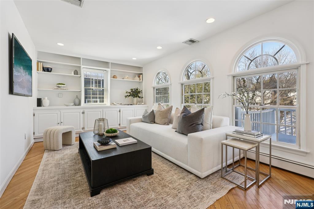 520 Hillcrest Road Ridgewood, NJ 07450 - Photo 6 of 27 a living room with furniture a fireplace and a flat screen tv