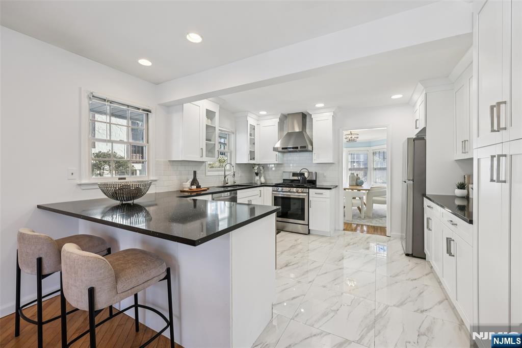 520 Hillcrest Road Ridgewood, NJ 07450 - Photo 10 of 27 a kitchen with stainless steel appliances granite countertop a sink and a refrigerator