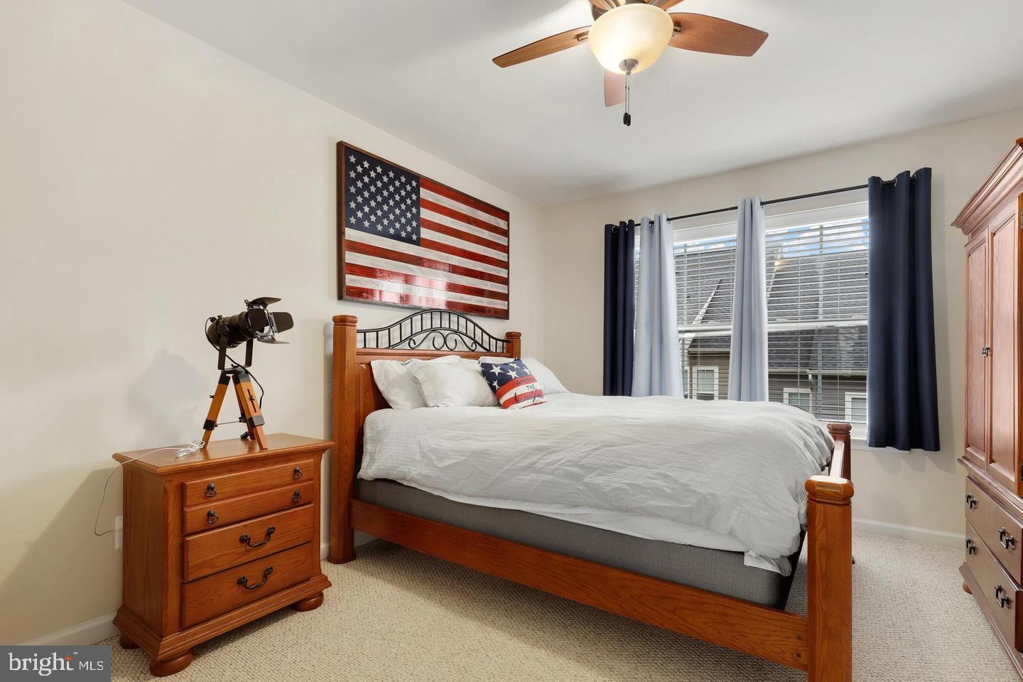 205 Woodstream Circle, Unit 2984 Stafford, VA 22556 - Photo 11 of 21 a bedroom with a bed and a chandelier