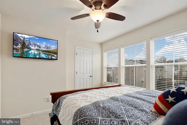 a bedroom with a large bed and a window