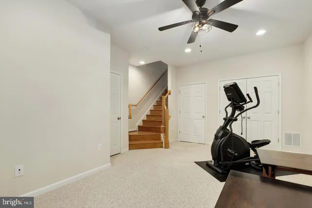 a room with gym equipment and windows
