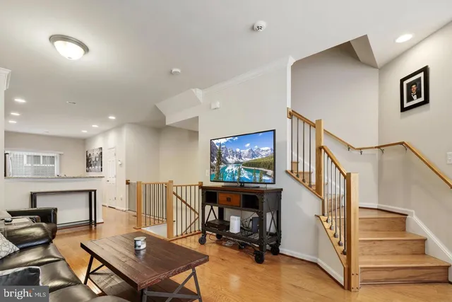 a living room with furniture a dining table and a piano