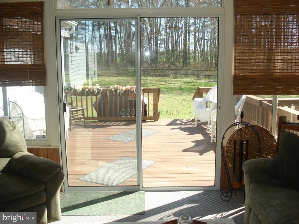 8037 Downs Road Newark, MD 21841 - Photo 17 of 23 a view of living room with a floor to ceiling window and an outdoor kitchen