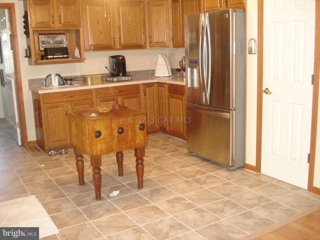 8037 Downs Road Newark, MD 21841 - Photo 10 of 23 a kitchen with stainless steel appliances a refrigerator sink and cabinets