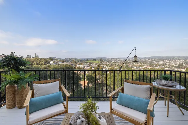 a view of a balcony with two chairs and a table