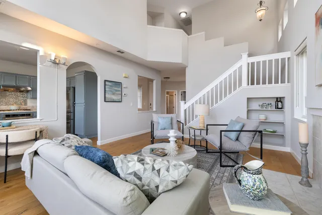 a living room with furniture and a dining table