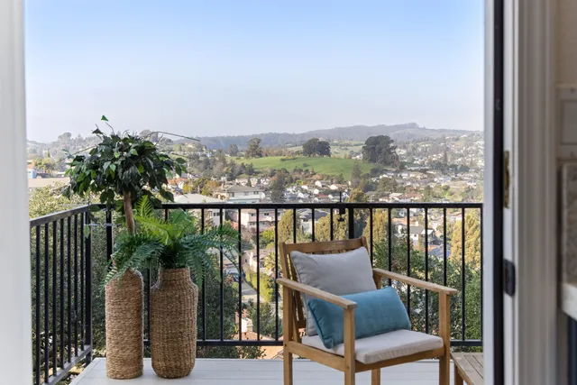 a view of a chair and table in the balcony