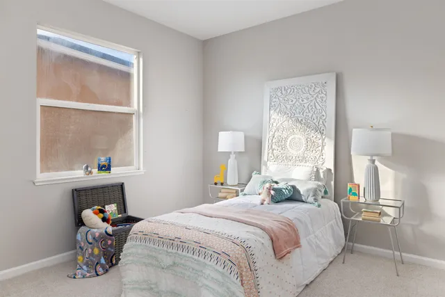 a bedroom with a bed and a window