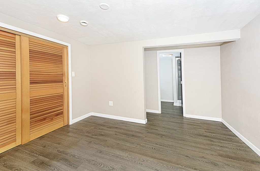 323 Mason Rd Extension Dudley, MA 01571 - Photo 34 of 37 an empty room with wooden floor and windows