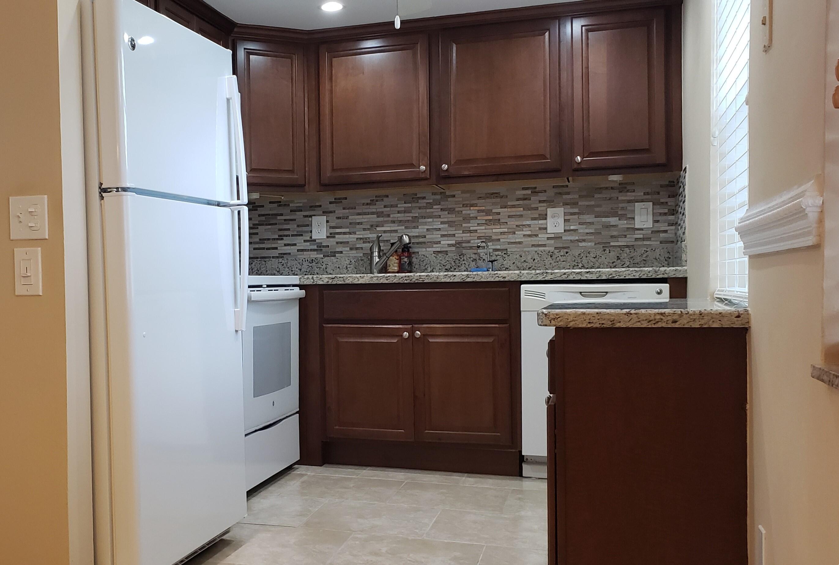 a kitchen with a refrigerator and cabinets