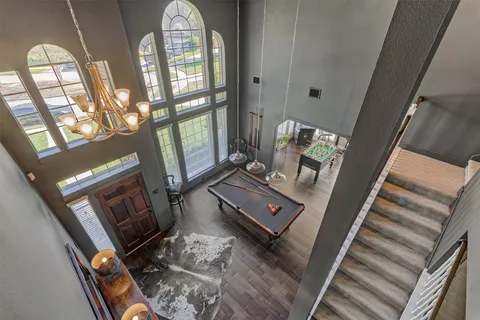 a bathroom with a granite countertop sink a toilet a mirror and shower