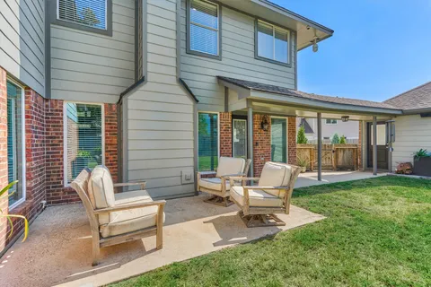 a view of a porch with a floor to ceiling window and wooden fence