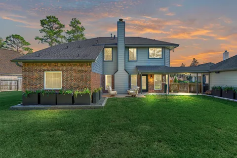 a view of a backyard with swimming pool and outdoor seating