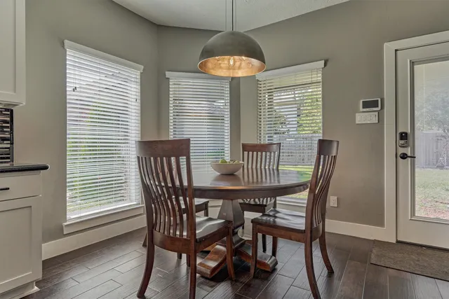 a dining room with furniture and wooden floor