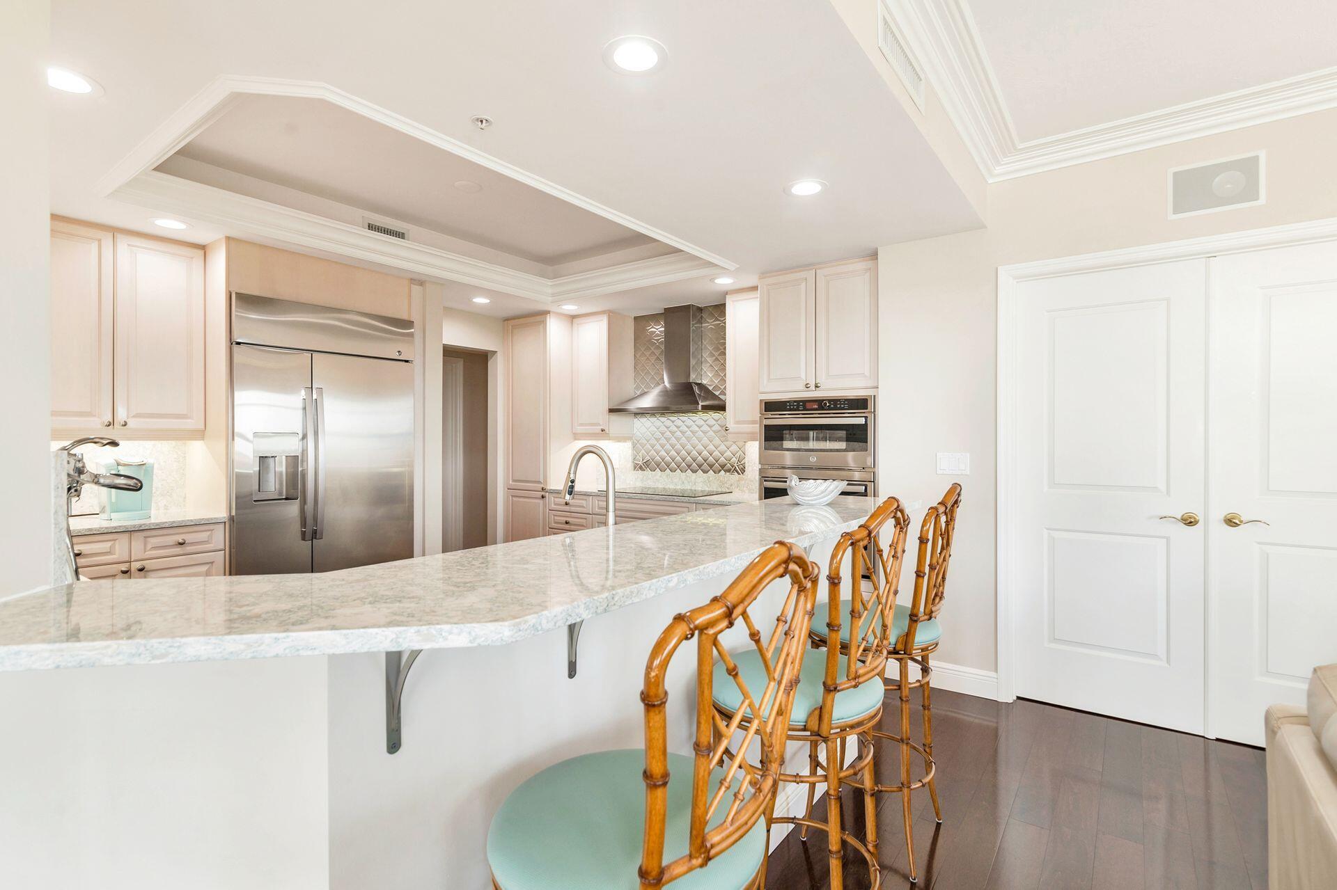 700 Highway 1, Unit 401 Jupiter, FL 33477 - Photo 17 of 39 a kitchen with stainless steel appliances granite countertop a sink refrigerator and cabinets