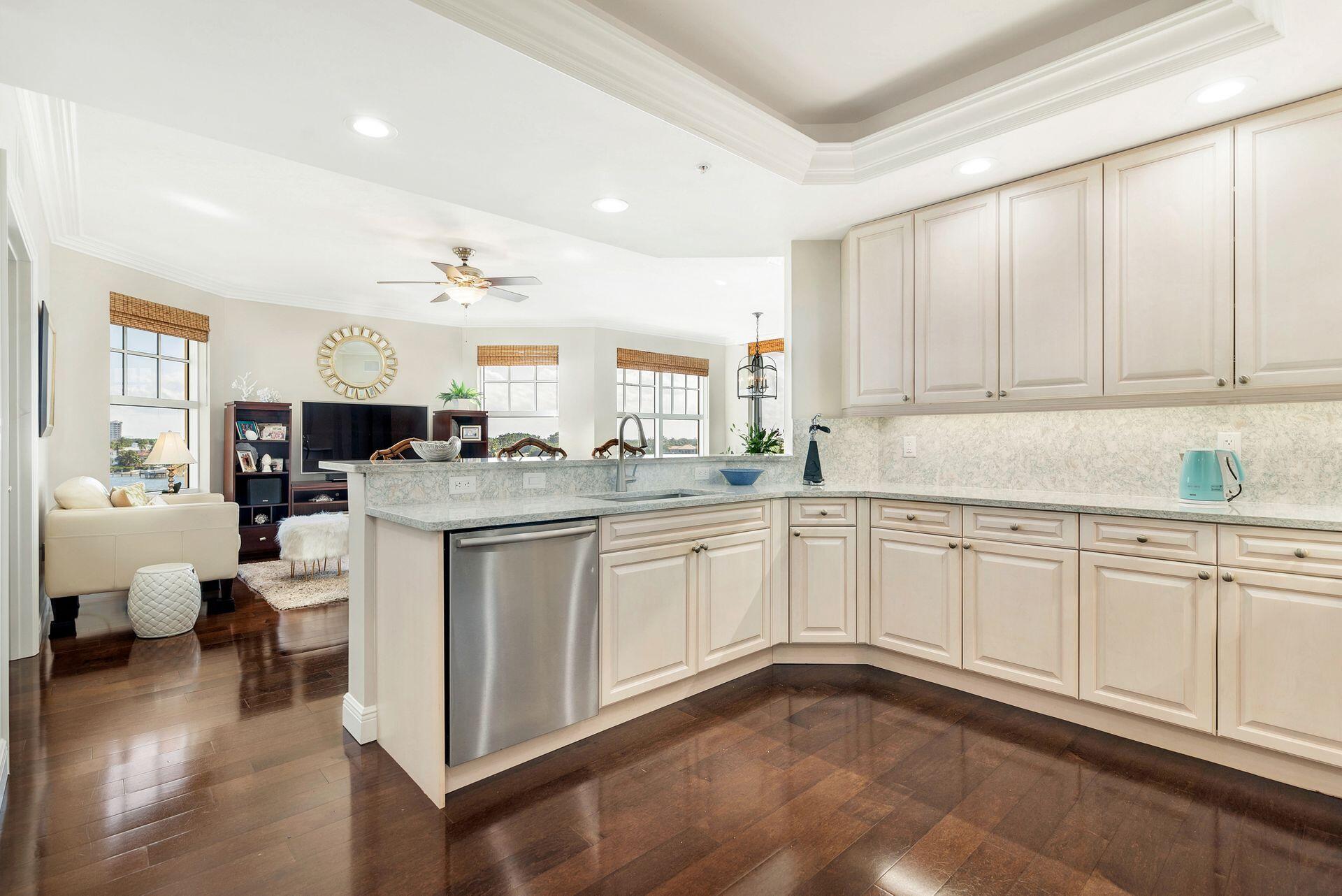 700 Highway 1, Unit 401 Jupiter, FL 33477 - Photo 20 of 39 a kitchen with granite countertop white cabinets and white appliances