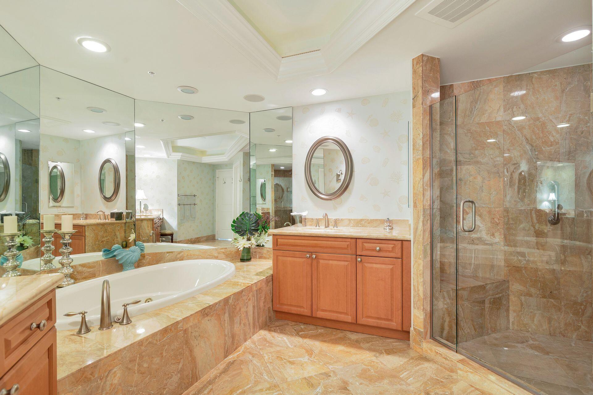 700 Highway 1, Unit 401 Jupiter, FL 33477 - Photo 27 of 39 a large bathroom with a large mirror vanity sink and a mirror