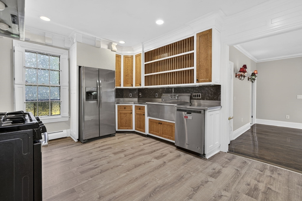 12 Crown Street Worcester, MA 01609 - Photo 13 of 42 a kitchen with stainless steel appliances a stove and a refrigerator