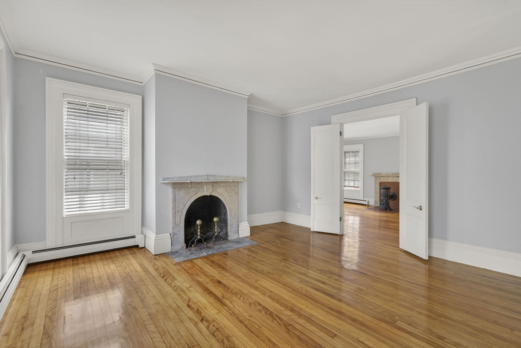 12 Crown Street Worcester, MA 01609 - Photo 16 of 42 a view of empty room with wooden floor and fireplace