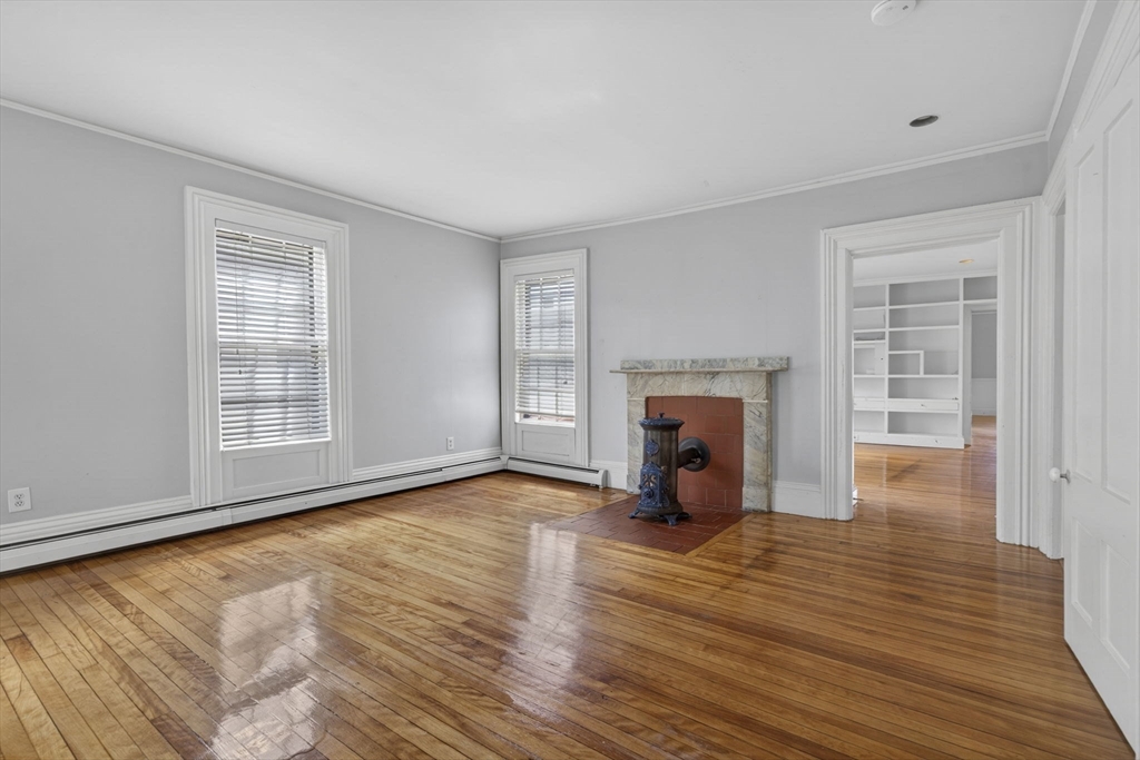 12 Crown Street Worcester, MA 01609 - Photo 18 of 42 wooden floor fireplace and windows in an empty room