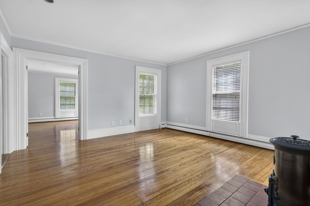 12 Crown Street Worcester, MA 01609 - Photo 19 of 42 a view of an empty room with wooden floor and a window