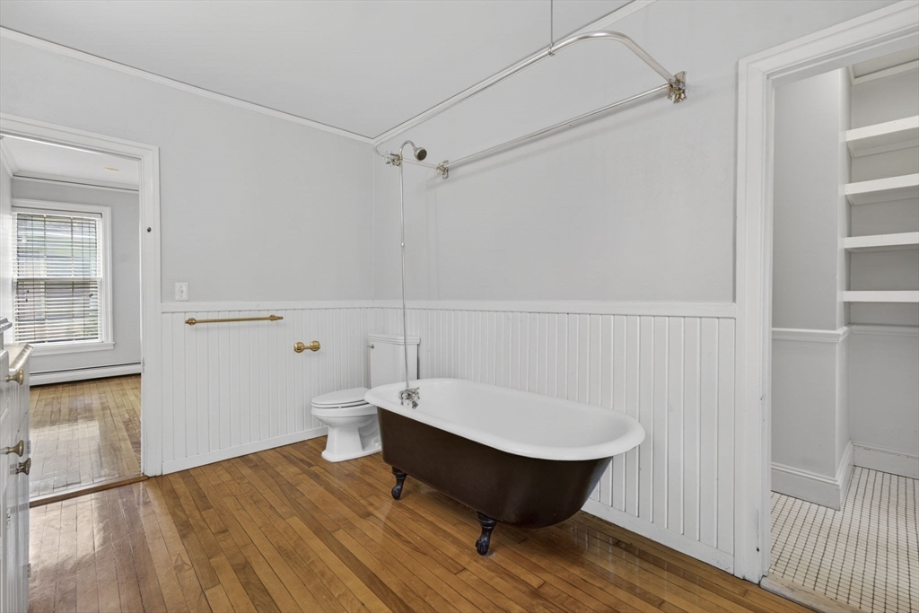 12 Crown Street Worcester, MA 01609 - Photo 24 of 42 a room with wooden floor and white walls