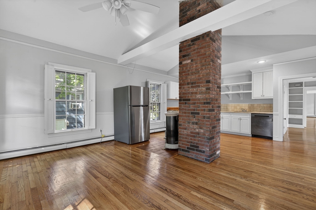 12 Crown Street Worcester, MA 01609 - Photo 29 of 42 a view of empty room with wooden floor and fireplace