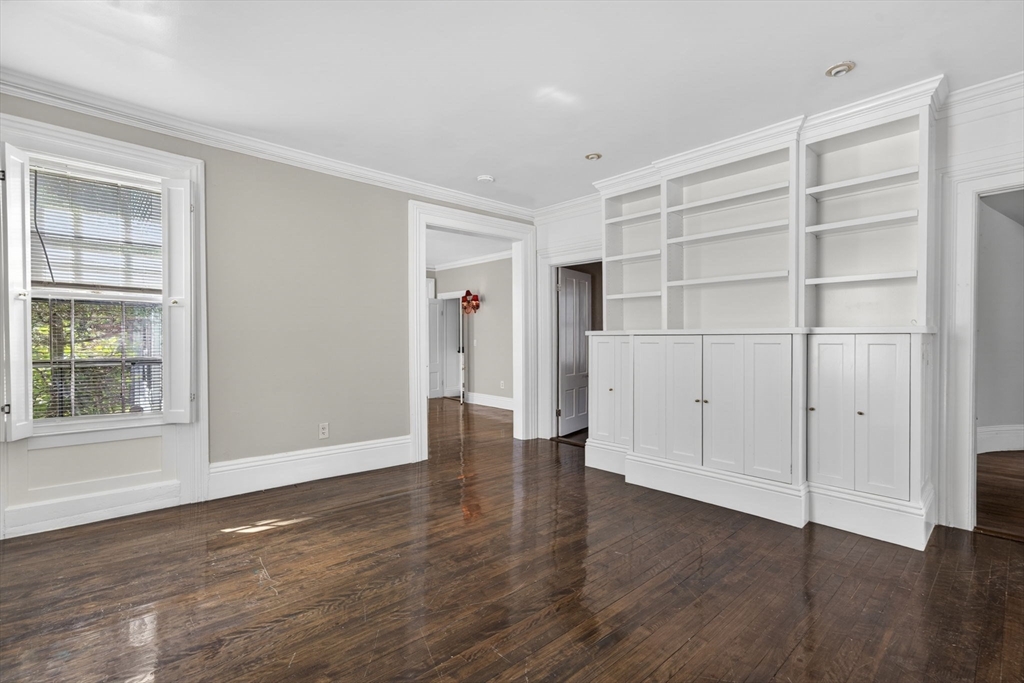12 Crown Street Worcester, MA 01609 - Photo 5 of 42 a view of an empty room with wooden floor and a window