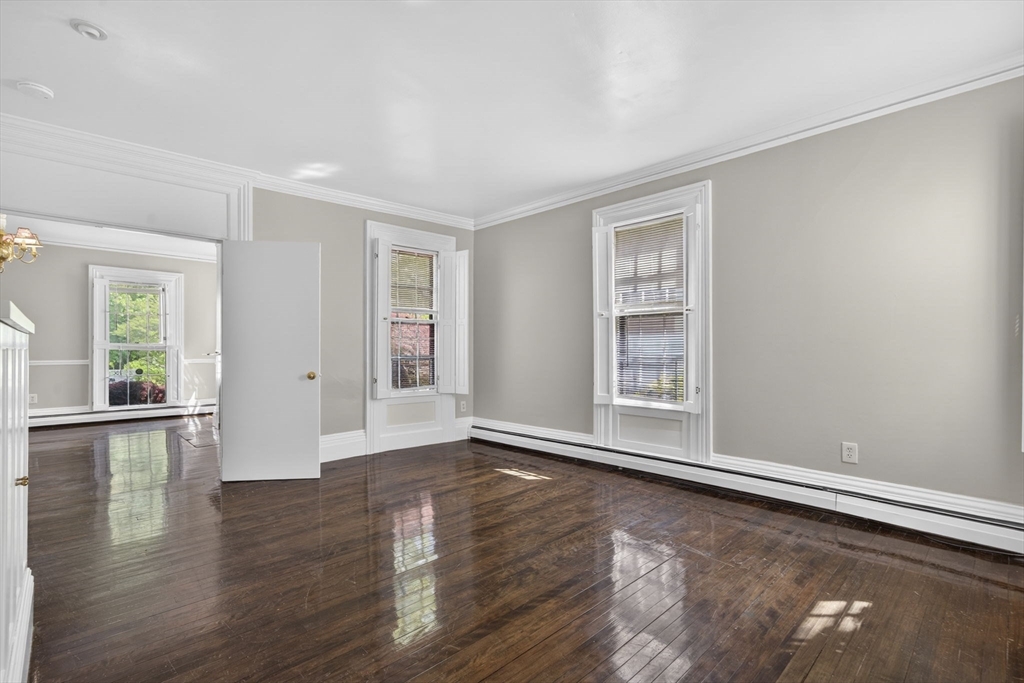 12 Crown Street Worcester, MA 01609 - Photo 6 of 42 a view of an empty room with wooden floor and a window