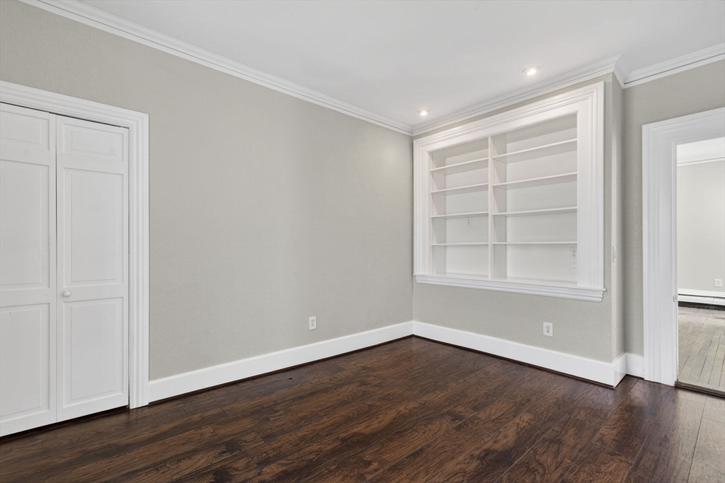 12 Crown Street Worcester, MA 01609 - Photo 7 of 42 a view of an empty room with wooden floor and a window