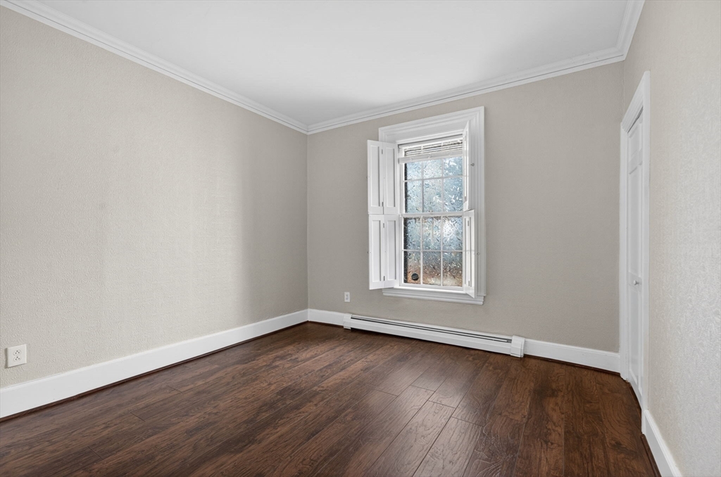 12 Crown Street Worcester, MA 01609 - Photo 8 of 42 an empty room with wooden floor and windows