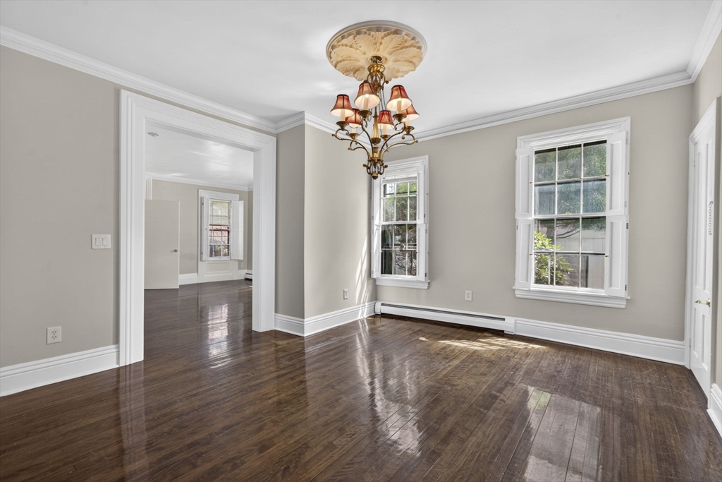 12 Crown Street Worcester, MA 01609 - Photo 9 of 42 a view of a livingroom with wooden floor and a chandelier