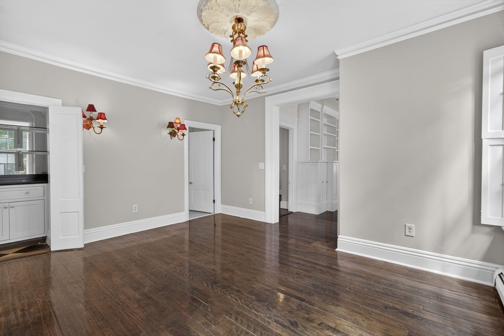 12 Crown Street Worcester, MA 01609 - Photo 10 of 42 an empty room with wooden floor and chandelier