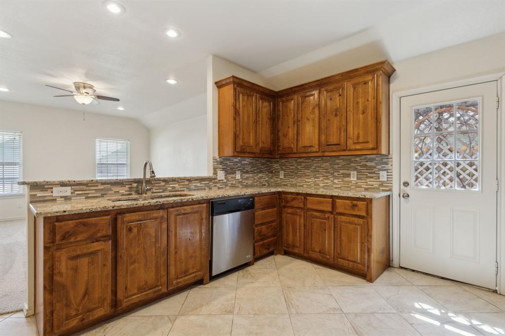 233 Firefly Drive Springtown, TX 76082 - Photo 5 of 16 Kitchen featuring granite countertops and built in cabinets.