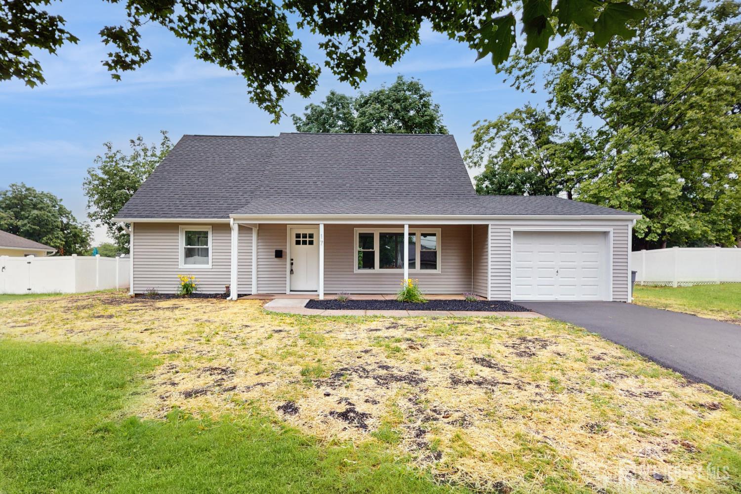 17 Tamarack Road Somerset, NJ 08873 - Photo 1 of 13 a front view of a house with a garden