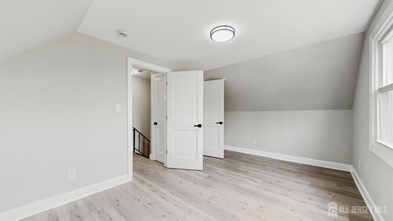 17 Tamarack Road Somerset, NJ 08873 - Photo 11 of 13 an empty room with wooden floor and windows