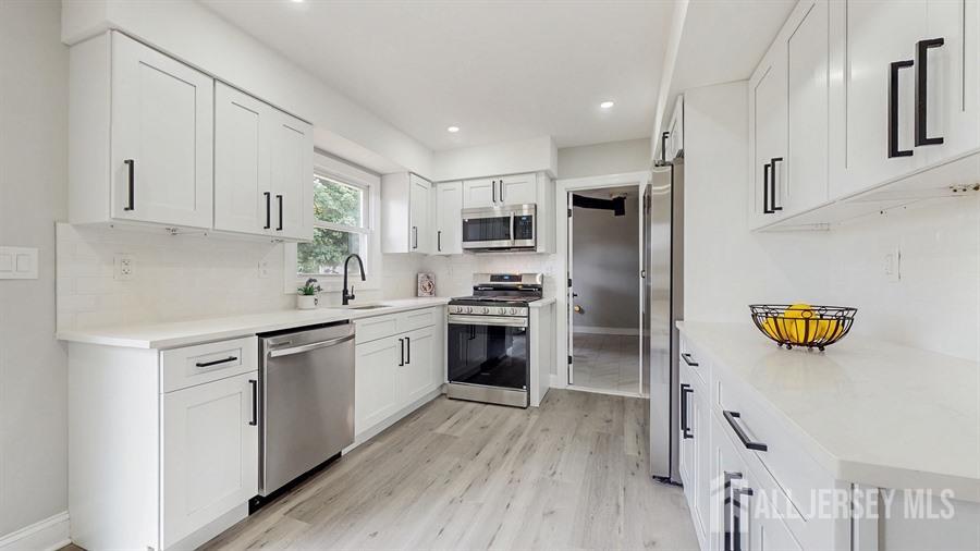 17 Tamarack Road Somerset, NJ 08873 - Photo 6 of 13 a kitchen with a refrigerator and a sink