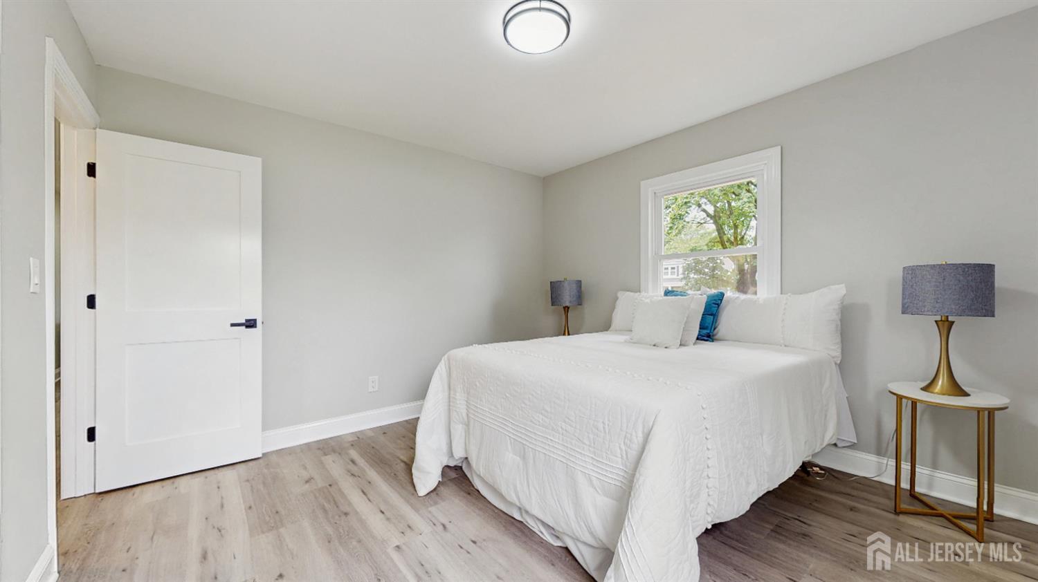 17 Tamarack Road Somerset, NJ 08873 - Photo 7 of 13 a bedroom with a bed and a lamp