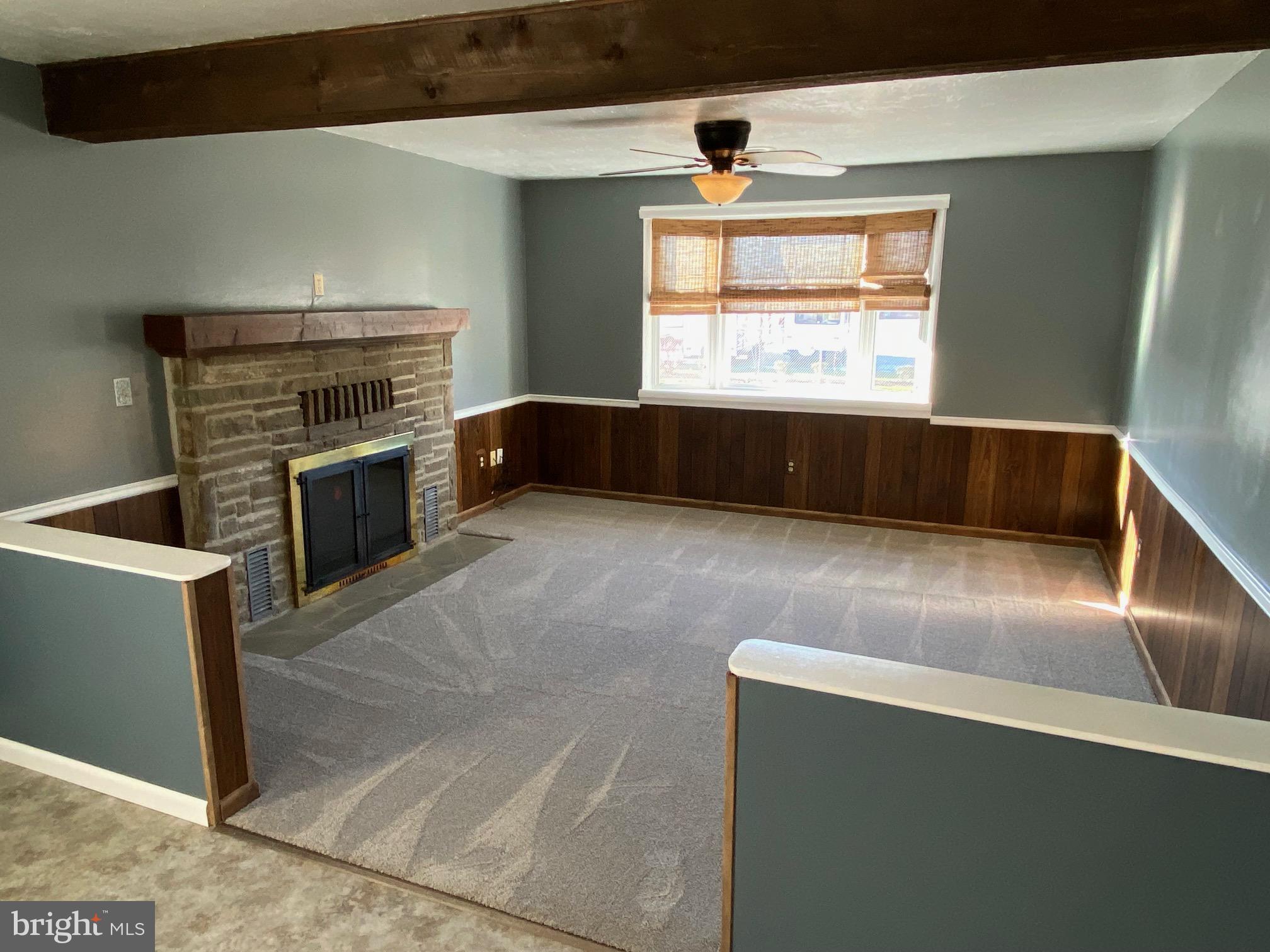 377 Juniper Lane Hanover, PA 17331 - Photo 8 of 24 a living room with stainless steel appliances wooden floor a fireplace and a window