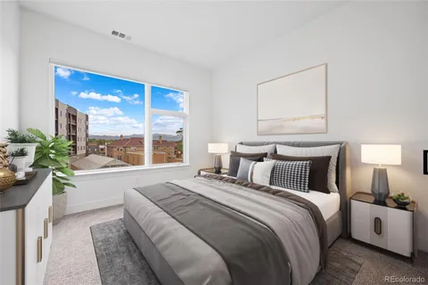 a bedroom with a large bed and a large window