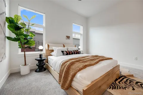 a bed sitting in a bedroom next to a window